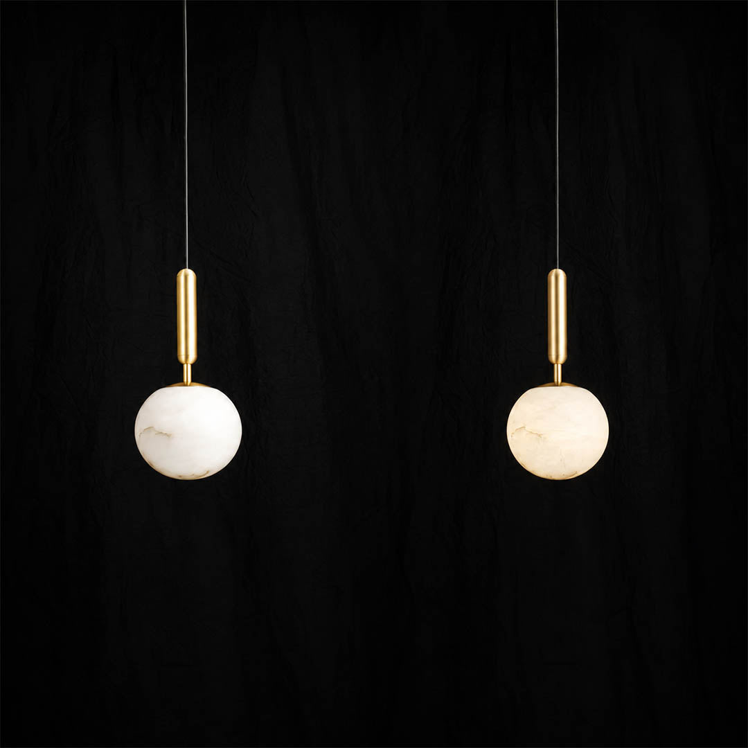 Sfera alabaster globe pendant light pair two natural stone spheres brass stems black cords white background front view