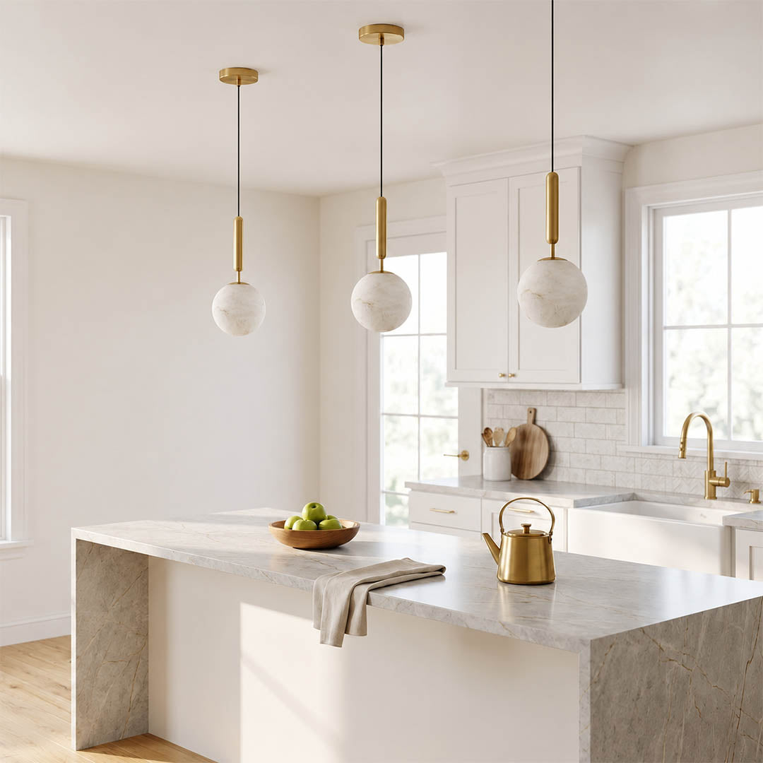 Sfera alabaster globe pendant light dining room above round table natural stone brass warm glow American home lifestyle interior styled