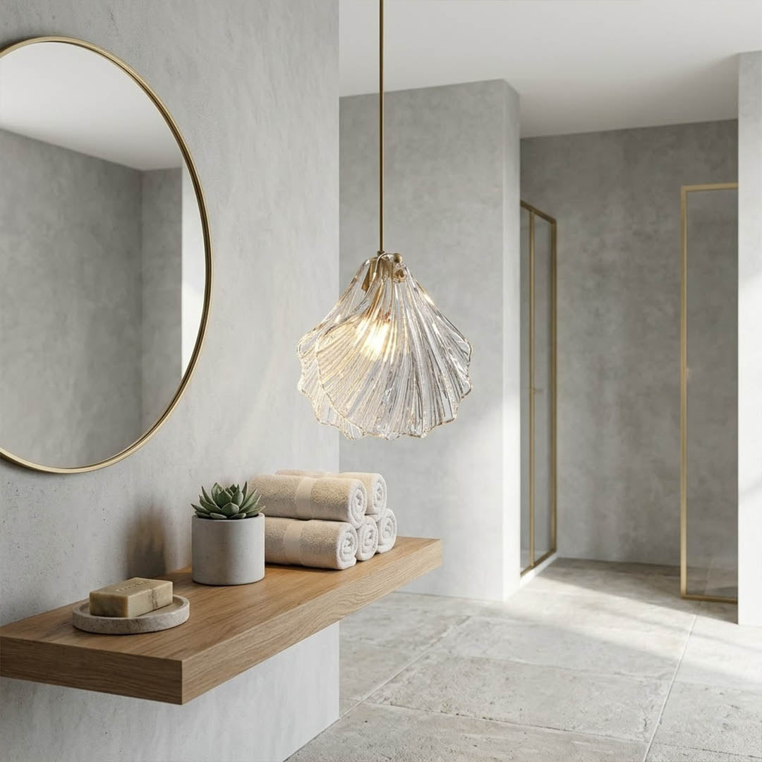 Shellie amber coastal pendant pair hanging above bathroom double vanity mirror brass warm sunset glow coastal modern interior