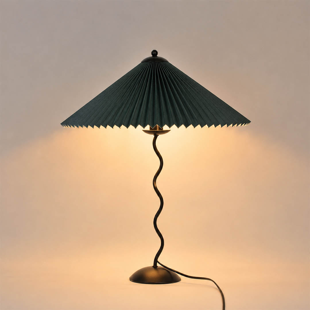 Sinuo table lamp modern sculptural squiggle wavy black metal base dark green forest fabric drum shade 17 inch wide 23.6 inch tall E14 postmodern Memphis inspired bold saturated statement bedside white background