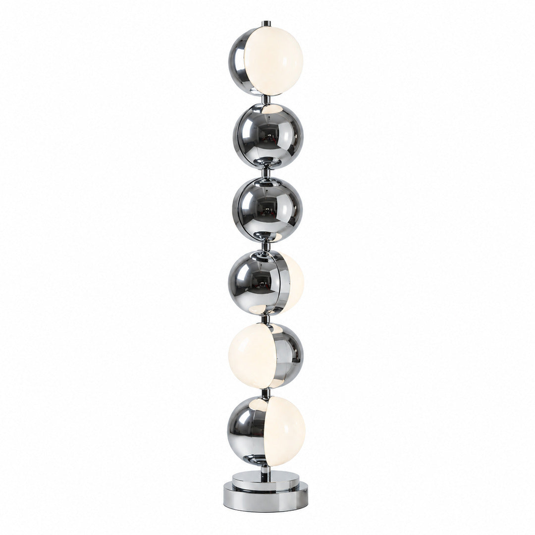 Slancio floor lamp with a slim polished chrome stem glowing warm in a modern living room corner