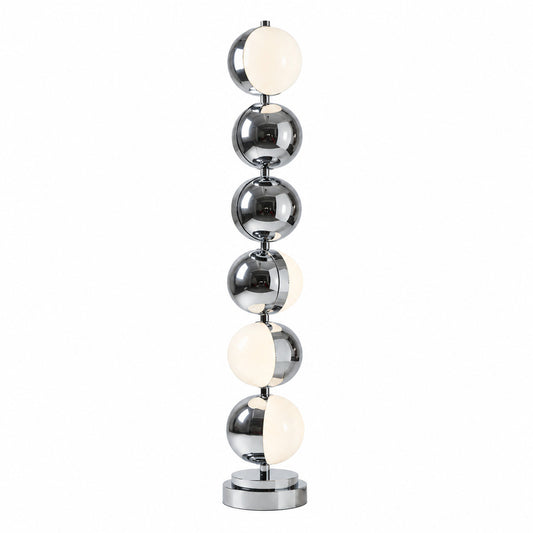 Slancio floor lamp with a slim polished chrome stem glowing warm in a modern living room corner
