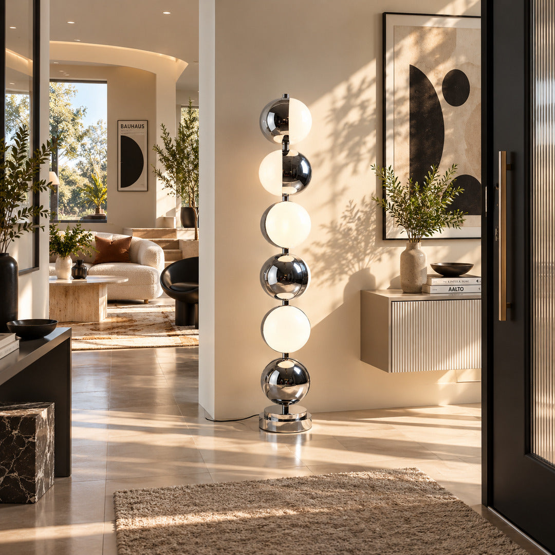 Slancio chrome floor lamp filling a living room corner with a soft warm glow