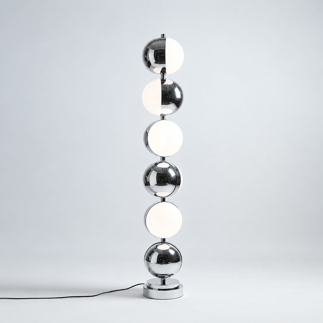 Close-up of the slim polished chrome stem and diffuser head of the Slancio floor lamp