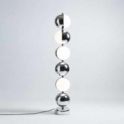 Close-up of the slim polished chrome stem and diffuser head of the Slancio floor lamp