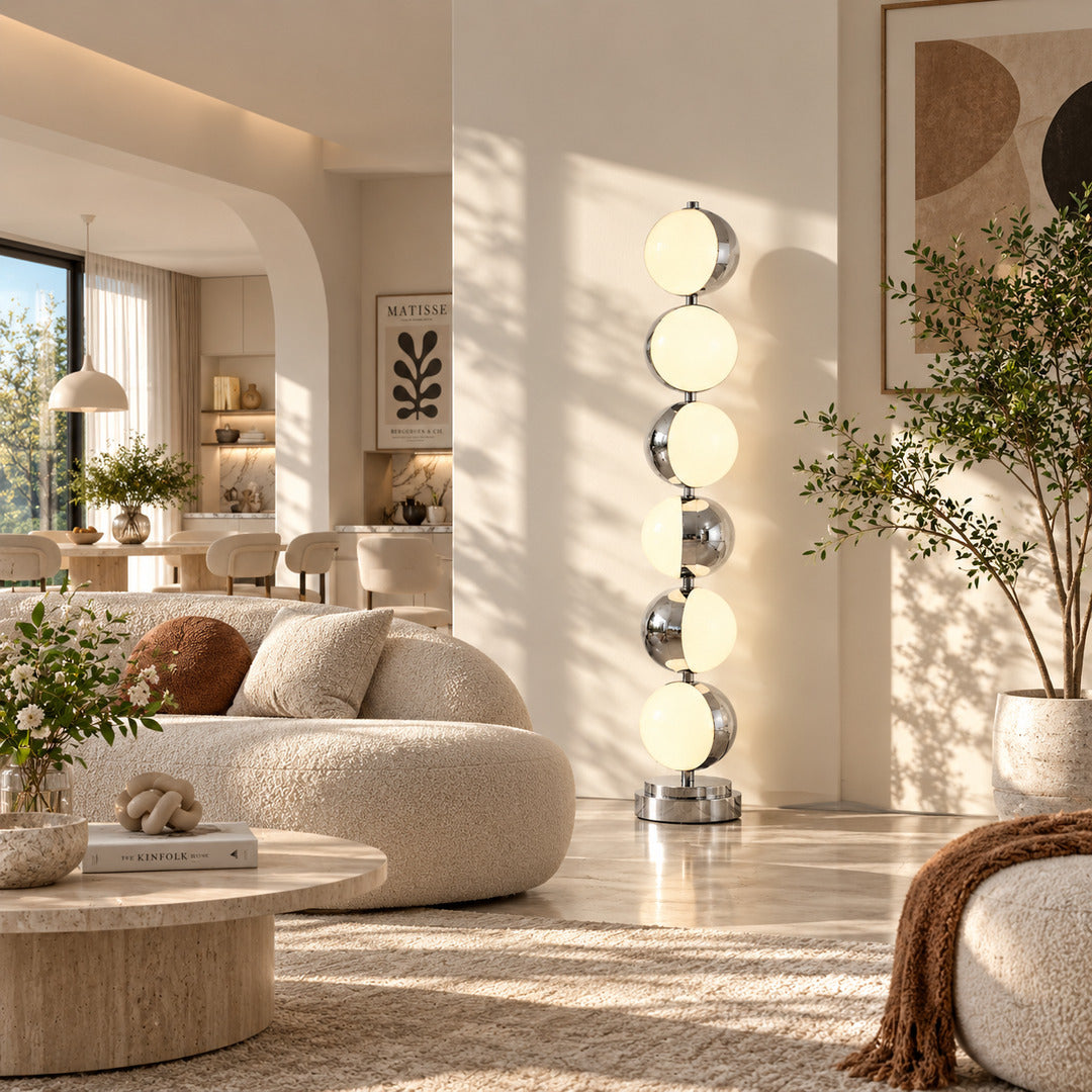 Slancio chrome floor lamp standing beside a sofa as a sleek minimalist accent