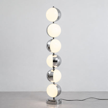 Close-up of the slim polished chrome stem and diffuser head of the Slancio floor lamp