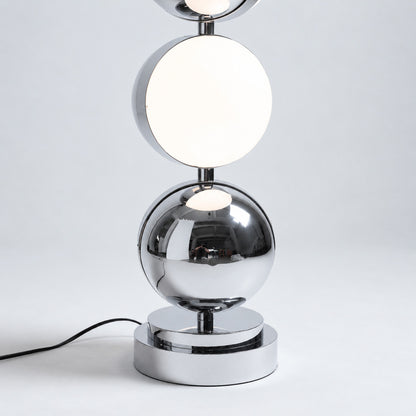 Soft warm glow diffusing from the acrylic head of the Slancio chrome floor lamp