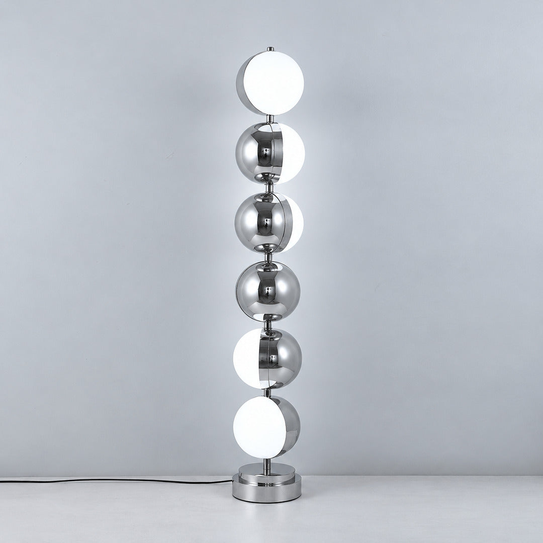 Slancio chrome floor lamp standing in a living room corner with a warm minimalist glow