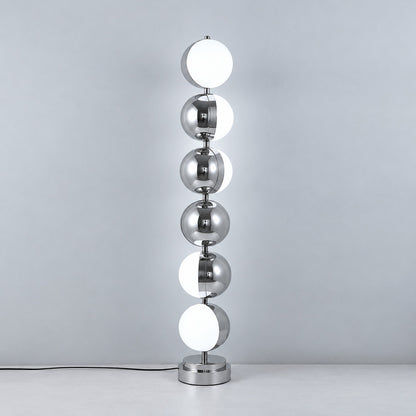 Slancio chrome floor lamp standing in a living room corner with a warm minimalist glow