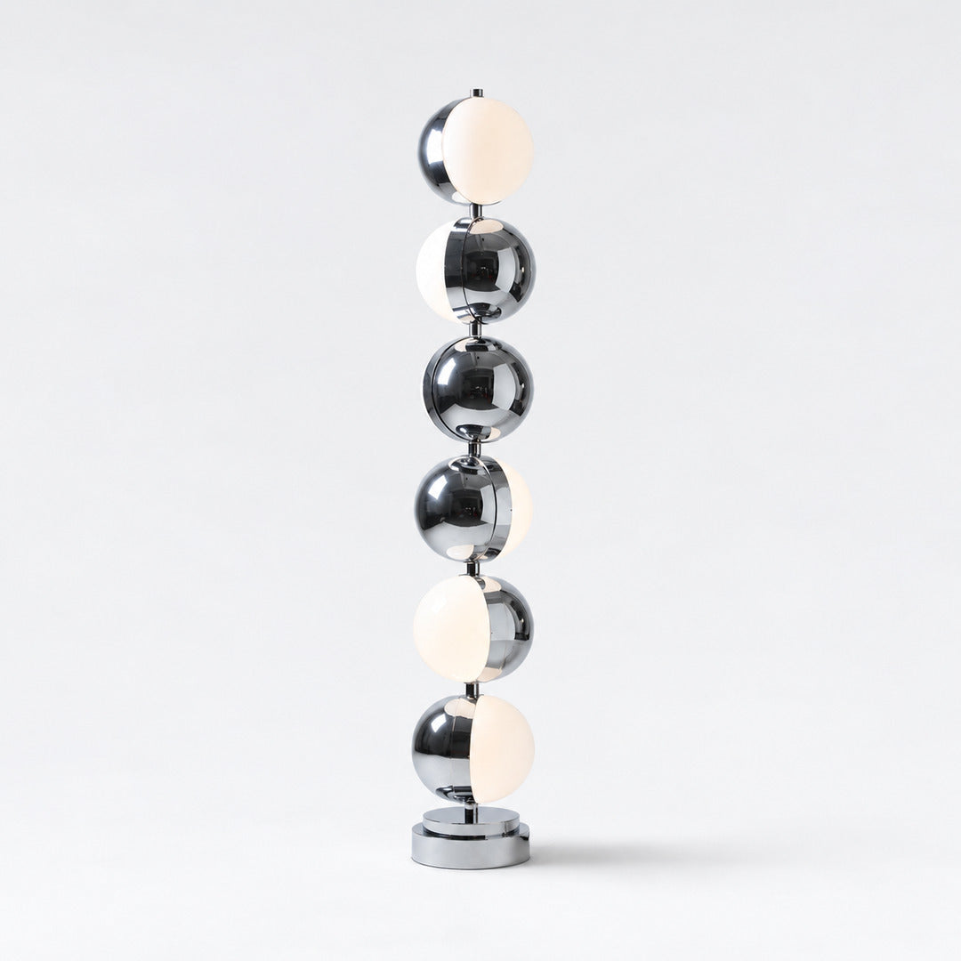 Slancio chrome floor lamp standing in a living room corner with a warm minimalist glow