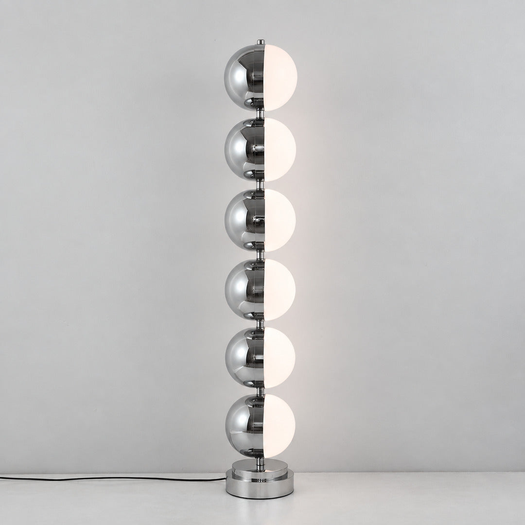 Close-up of the slim polished chrome stem and diffuser head of the Slancio floor lamp