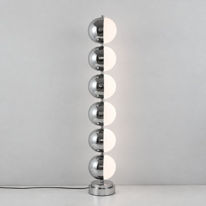 Close-up of the slim polished chrome stem and diffuser head of the Slancio floor lamp