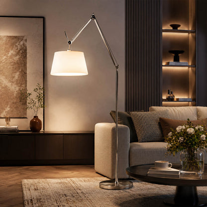 The 95.7-inch Snodo floor lamp arcing over the back of a sofa in an American living room, delivering direct reading light without a side table