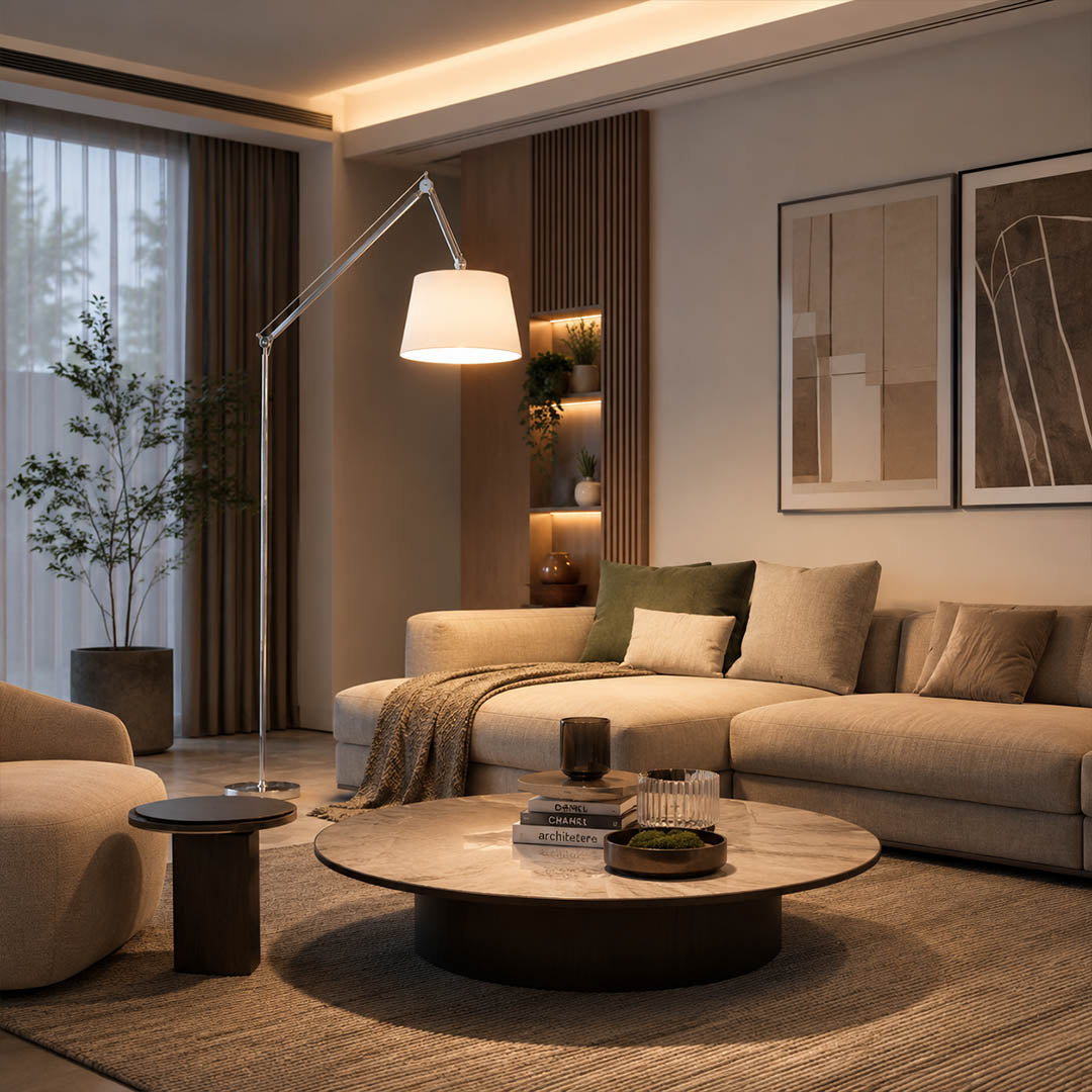 Tall Snodo floor lamp arcing over a linen sectional in a modern American living room, warm evening reading light