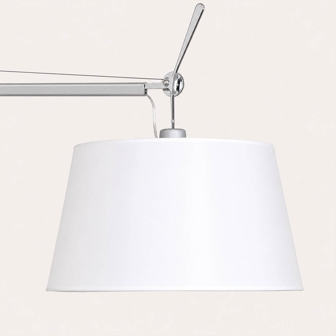 Close-up of the Snodo floor lamp swing-arm joint showing the adjustable pivot connection