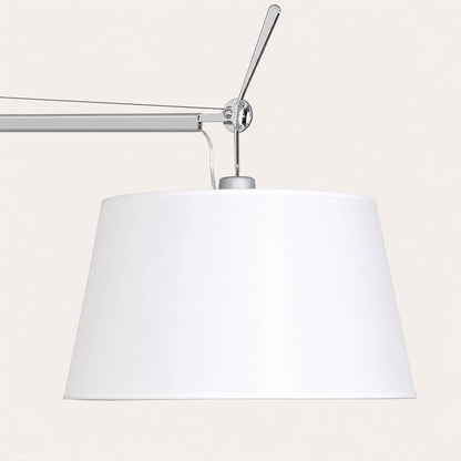 Close-up of the Snodo floor lamp swing-arm joint showing the adjustable pivot connection