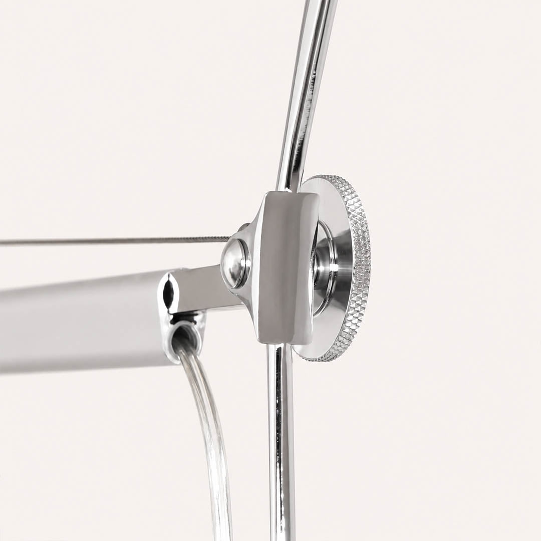 Close-up of the Snodo floor lamp swing-arm joint showing the adjustable pivot connection
