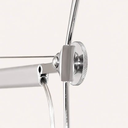 Close-up of the Snodo floor lamp swing-arm joint showing the adjustable pivot connection