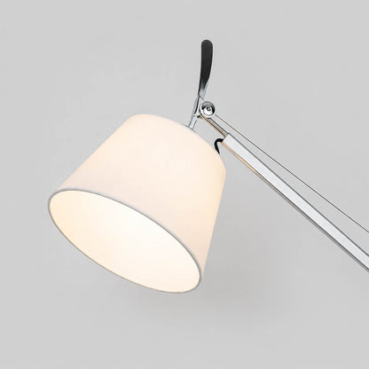 Close-up of the Snodo floor lamp swing-arm joint showing the adjustable pivot connection