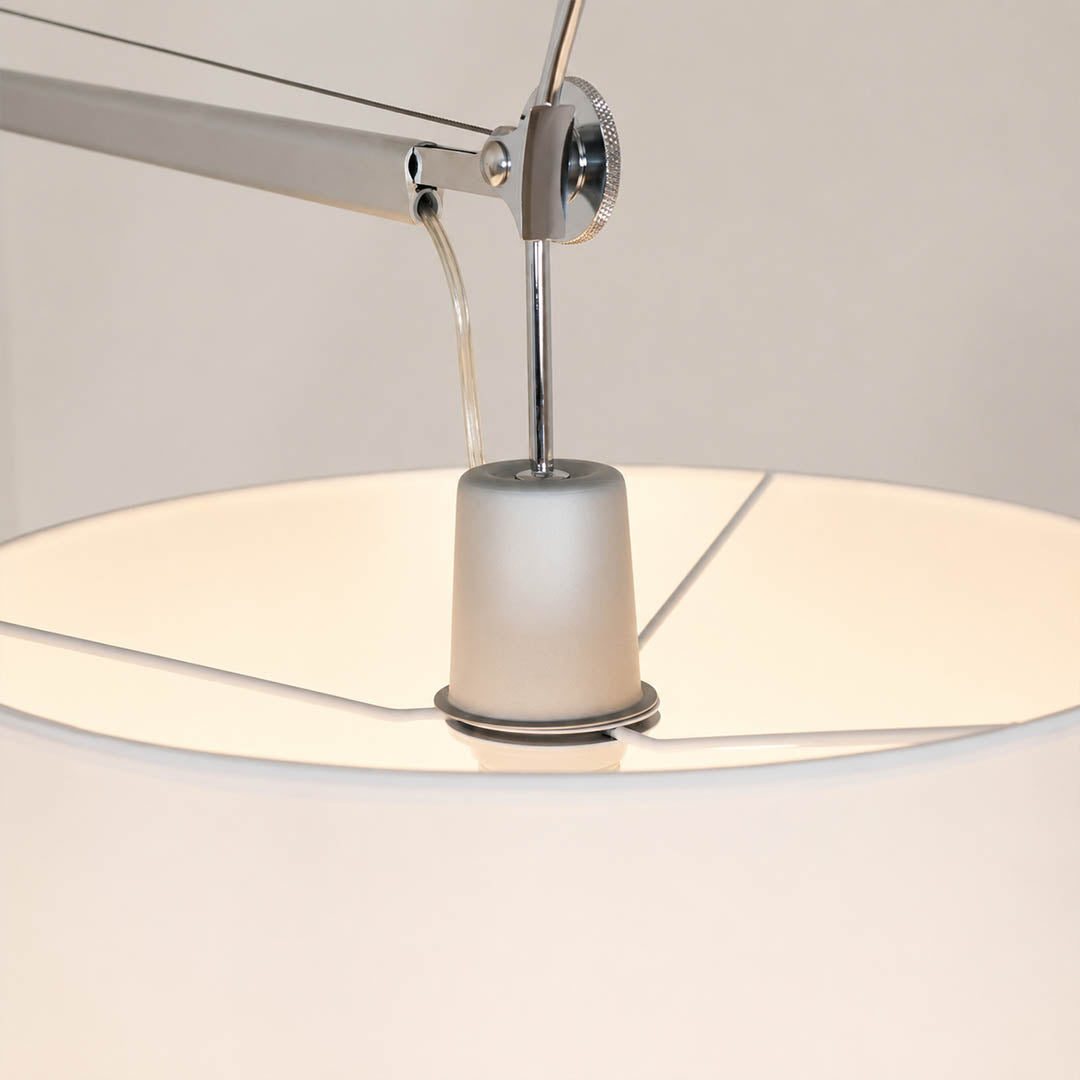 Close-up of the Snodo floor lamp swing-arm joint showing the adjustable pivot connection
