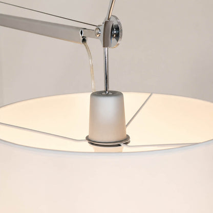 Close-up of the Snodo floor lamp swing-arm joint showing the adjustable pivot connection