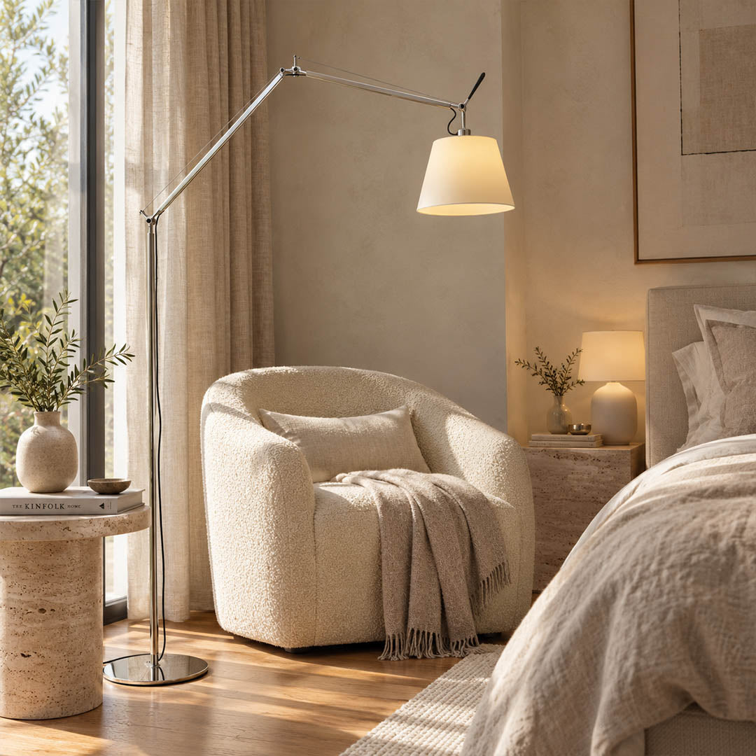 Snodo floor lamp positioned beside a leather armchair in a corner reading nook with a stack of books