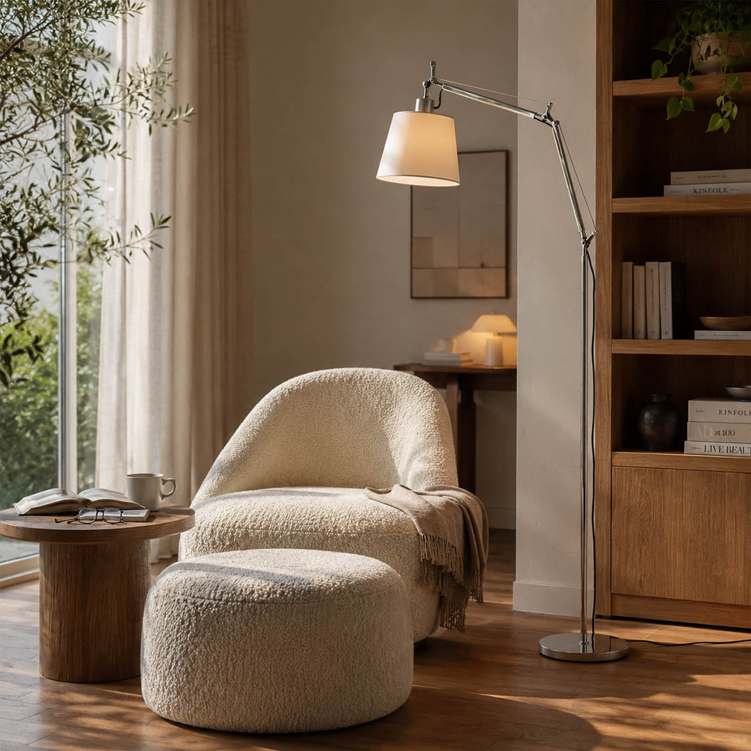 Snodo floor lamp positioned beside a leather armchair in a corner reading nook with a stack of books