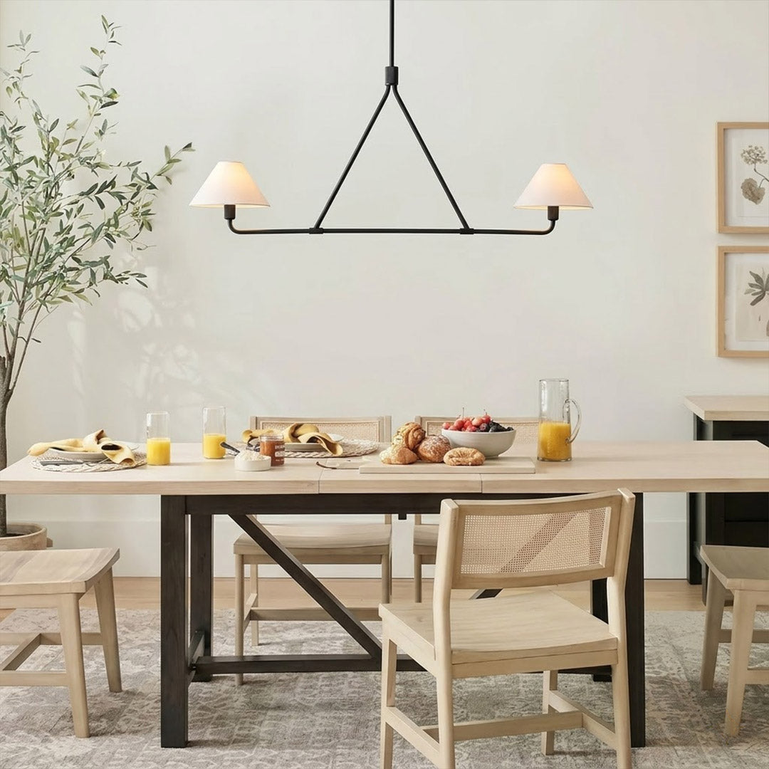 Sola black angular chandelier above dining table warm fabric drum shade light japandi interior