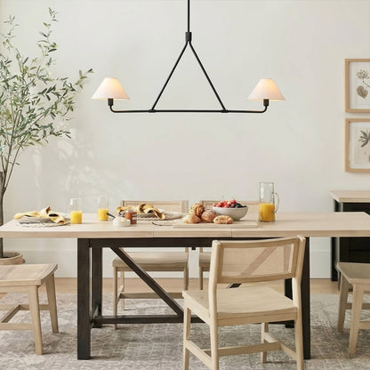 Sola black angular chandelier above dining table warm fabric drum shade light japandi interior