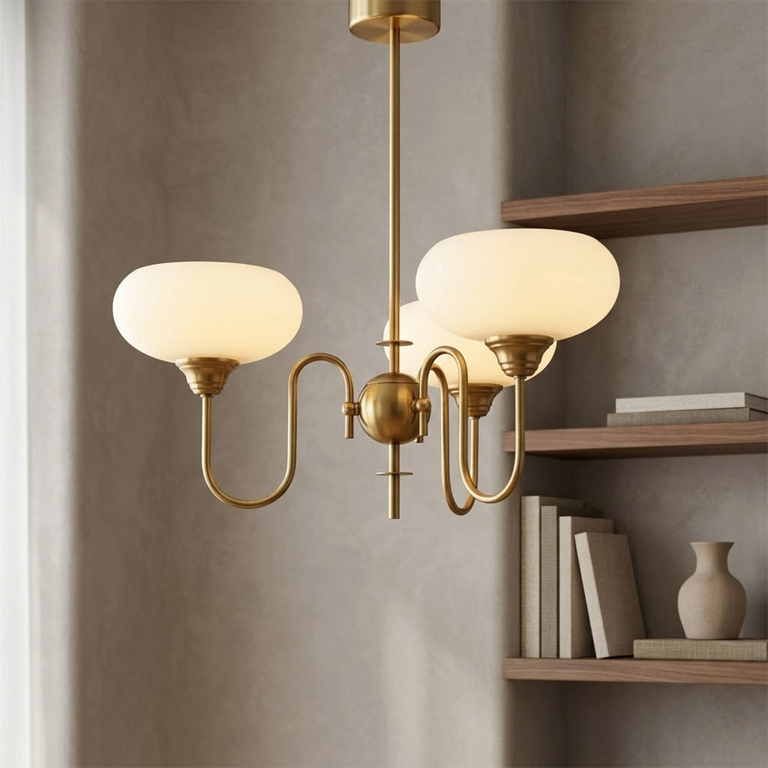 Solari cream glass chandelier above dining table warm amber gold light organic modern interior