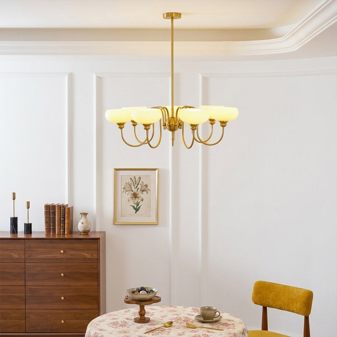 Solari cream glass chandelier above dining table warm amber gold light organic modern interior