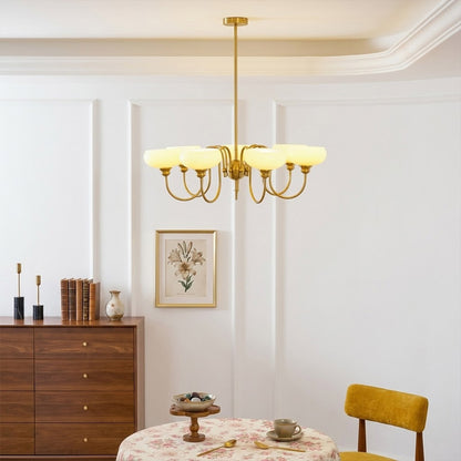 Solari cream glass chandelier above dining table warm amber gold light organic modern interior