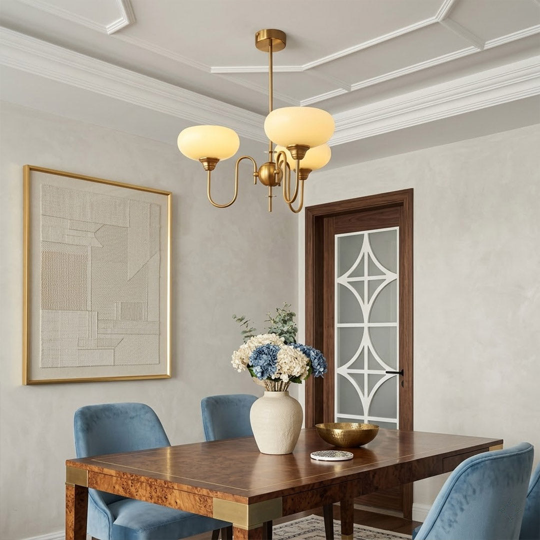 Solari cream glass chandelier above dining table warm amber gold light organic modern interior