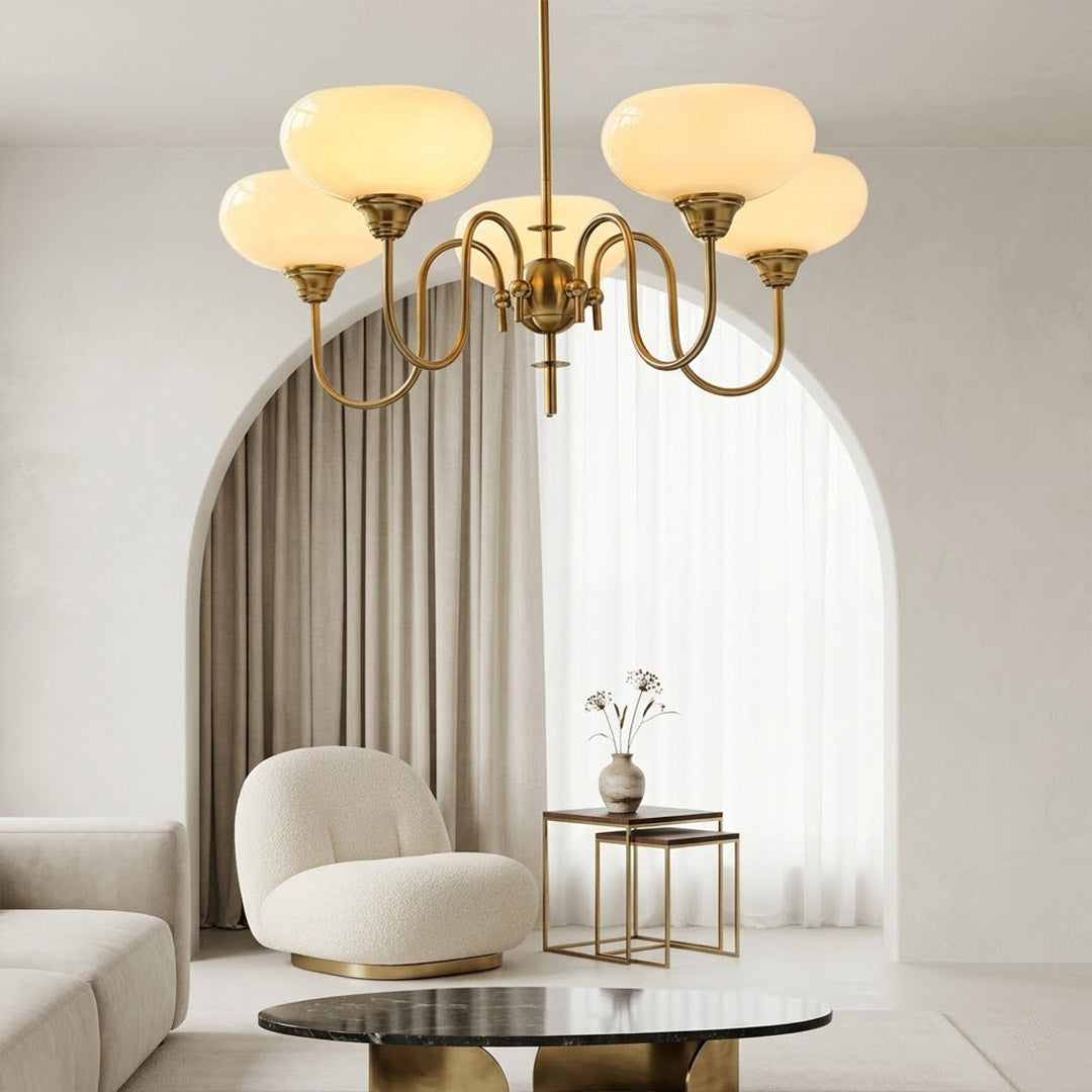 Solari cream glass chandelier above dining table warm amber gold light organic modern interior