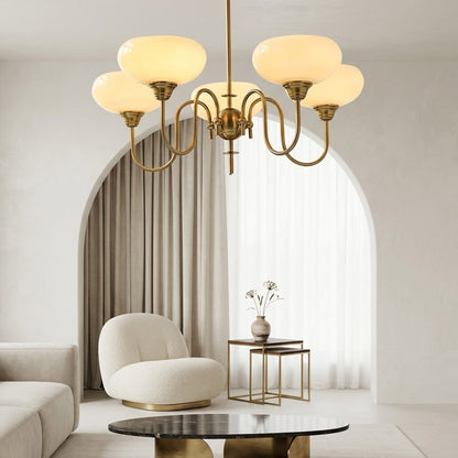 Solari cream glass chandelier above dining table warm amber gold light organic modern interior