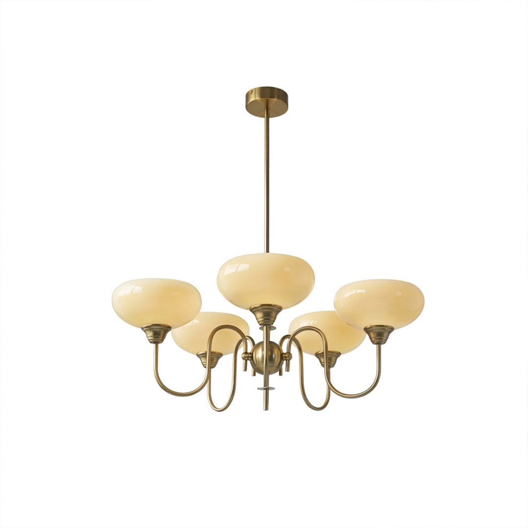 Solari cream glass chandelier above dining table warm amber gold light organic modern interior