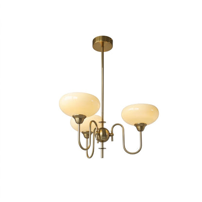 Solari cream glass chandelier above dining table warm amber gold light organic modern interior