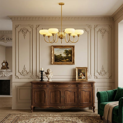 Solari cream glass chandelier above dining table warm amber gold light organic modern interior