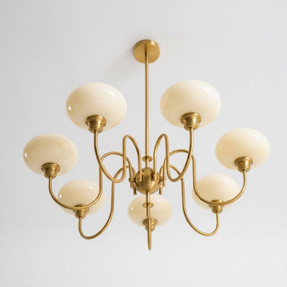 Solari cream glass chandelier above dining table warm amber gold light organic modern interior