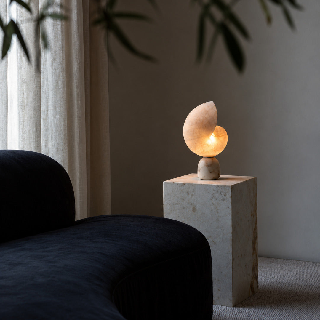 Spira alabaster shell lamp on a mid-century credenza in a living room