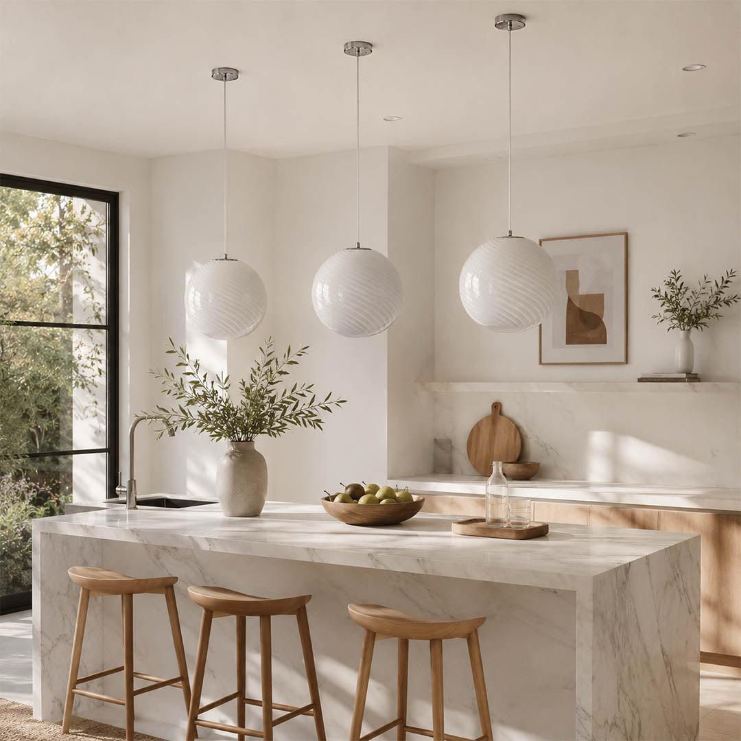 Spira pendant light white trio triple 3 pendants row modern kitchen island counter hand blown spiral ribbed glass sphere neutral minimalist warm ambient lifestyle interior American home