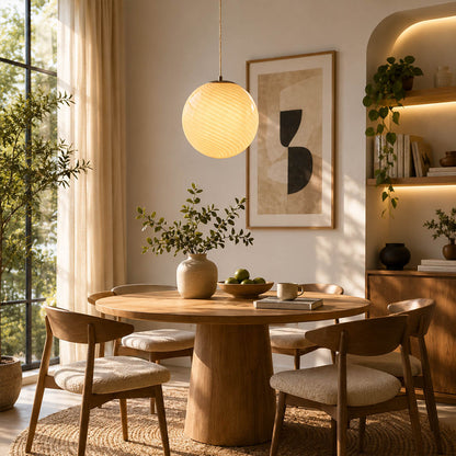 Spira pendant light white single modern dining room round table centerpiece hand blown spiral ribbed glass sphere minimalist neutral warm ambient lifestyle interior American home