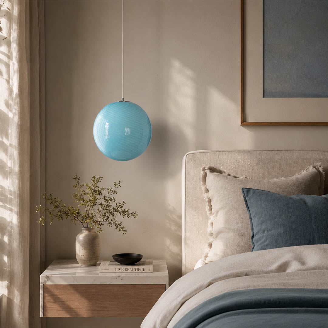Spira pendant light light blue single modern primary bedroom bedside above nightstand hand blown spiral ribbed glass sphere pastel calm serene warm ambient intimate cozy lifestyle interior American home