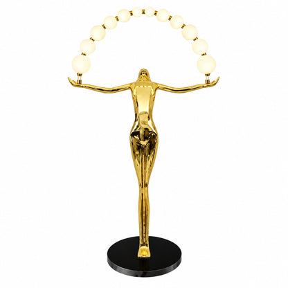 Statue of Liberty floor lamp with a tall figure sculpture holding an arc of glowing glass orbs in a living room
