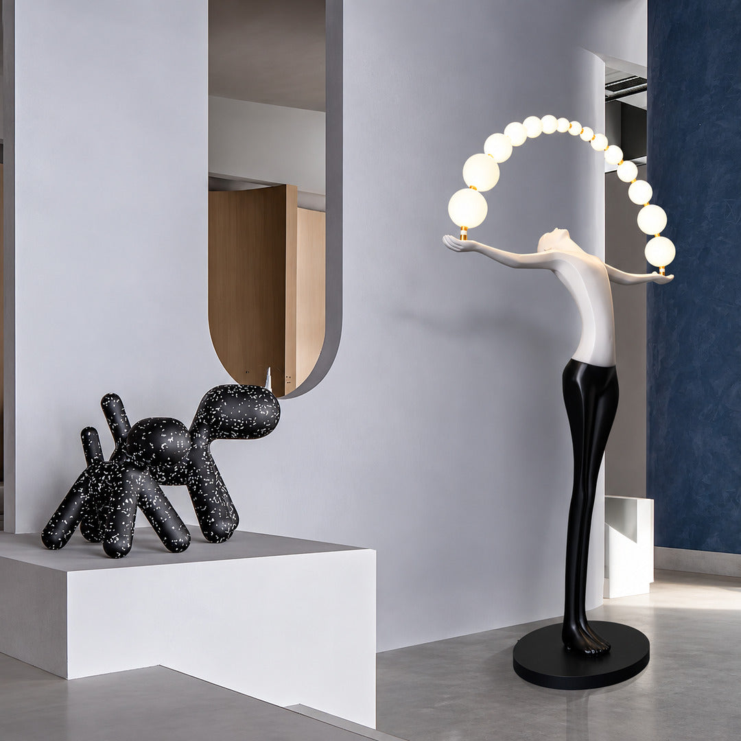 Statue of Liberty floor lamp displayed as a functional light sculpture in a contemporary gallery
