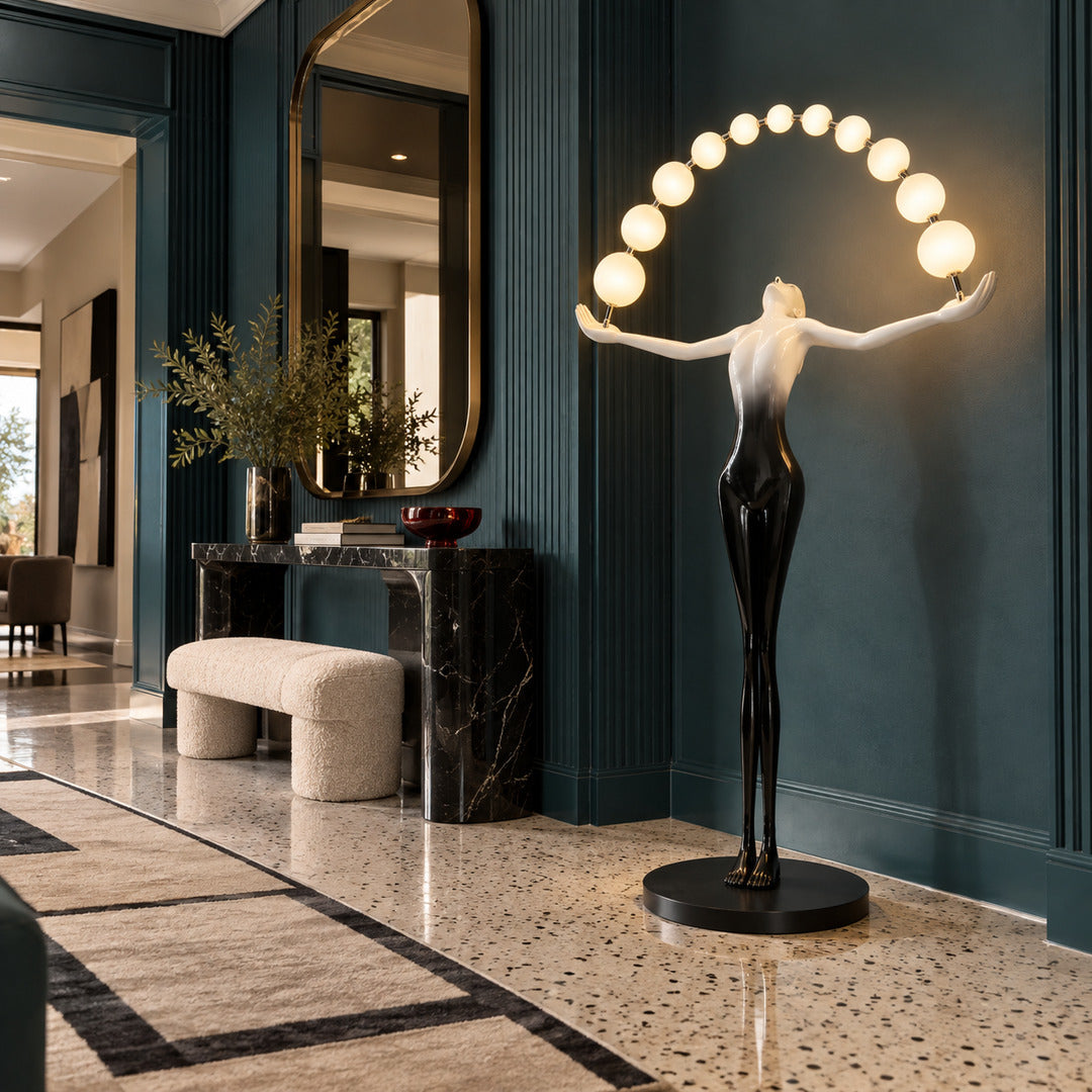 Statue of Liberty floor lamp welcoming guests with a glowing arc of orbs in a grand entryway