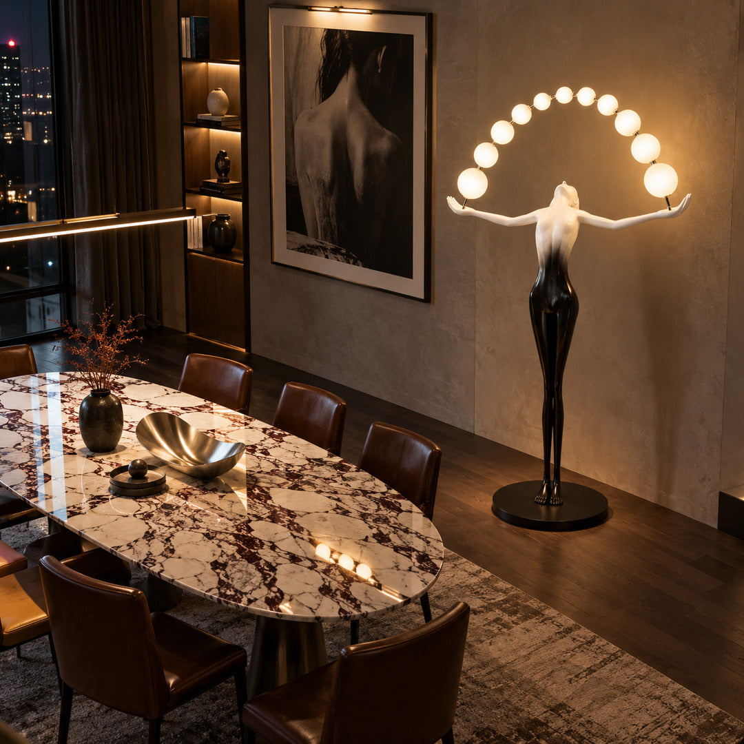 Tall Statue of Liberty floor lamp anchoring a double-height living room with its glowing arc