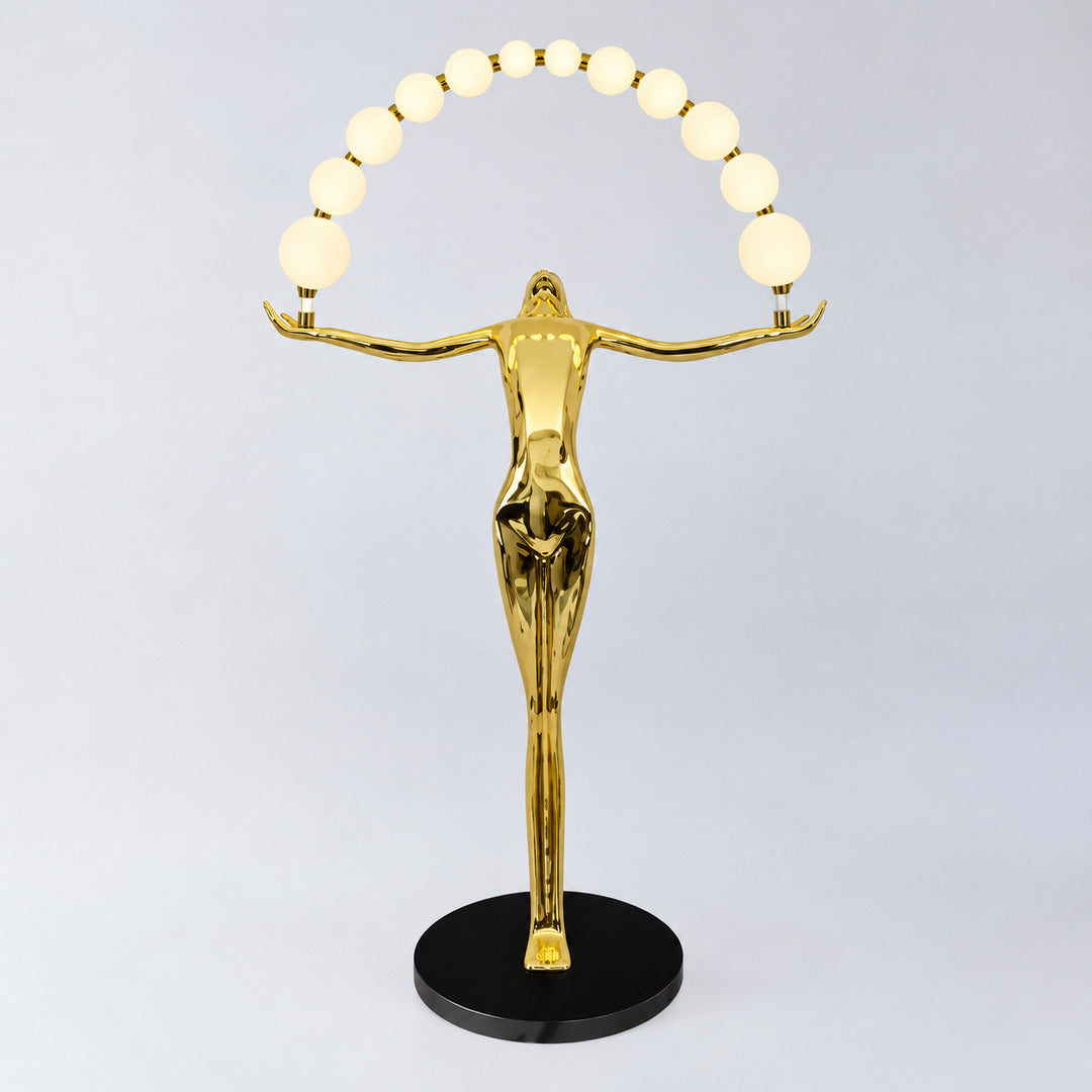 Gold Statue of Liberty floor lamp as a warm luxe sculptural focal point in a refined space