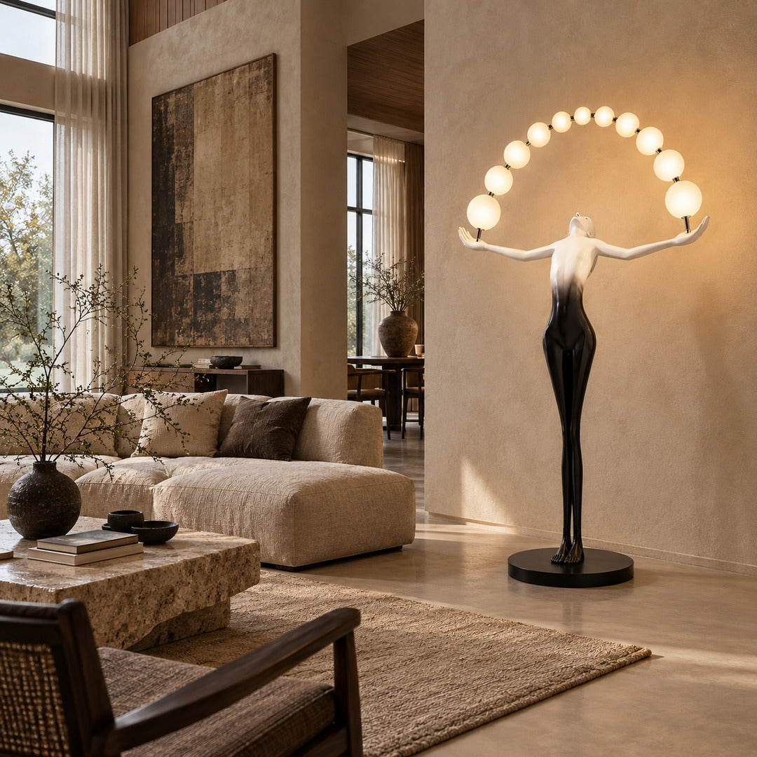 Tall Statue of Liberty floor lamp anchoring a double-height living room with its glowing arc